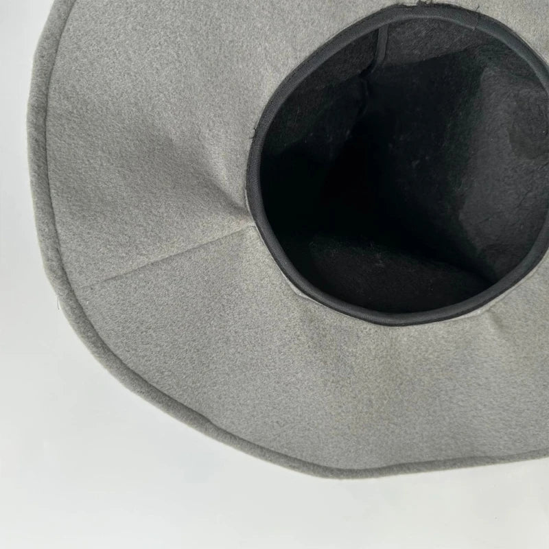 A gray witch hat with a dark interior, shown from above.
