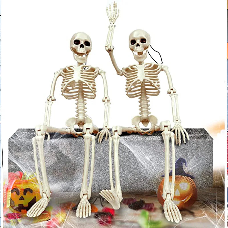 A pair of poseable human skeleton decorations with movable bones displayed on a gray box.
