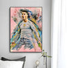 A modern wall art print featuring a painting of Cristiano Ronaldo celebrating with vibrant pink, blue, and yellow brushstroke