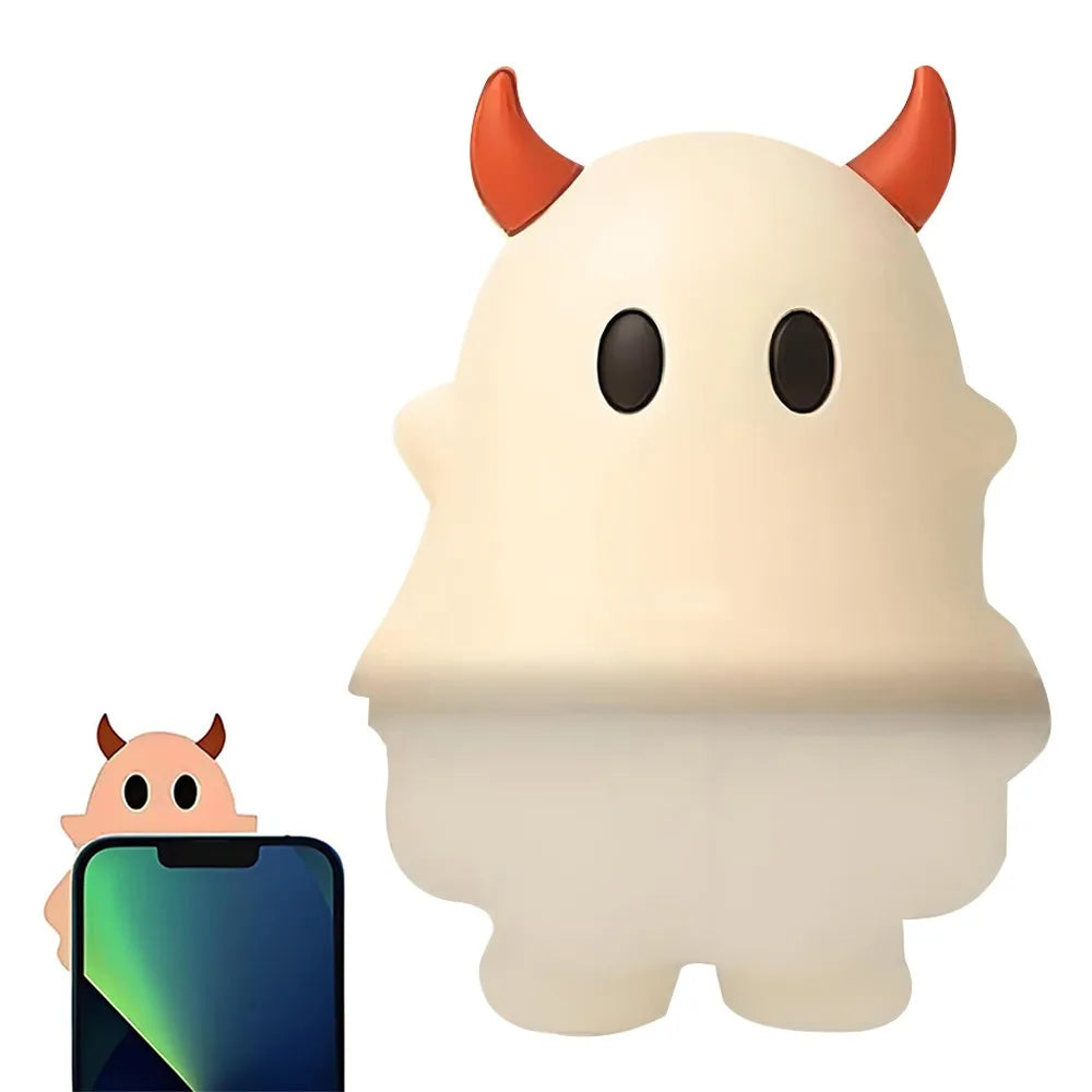 A white ghost phone decoration charm is shown next to a smartphone.