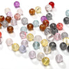 A collection of round glass spacer beads in various colors including purple, pink, amber, and clear shades.
