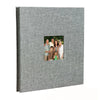 A grey linen front scrapbook memory book with a photo of a family.