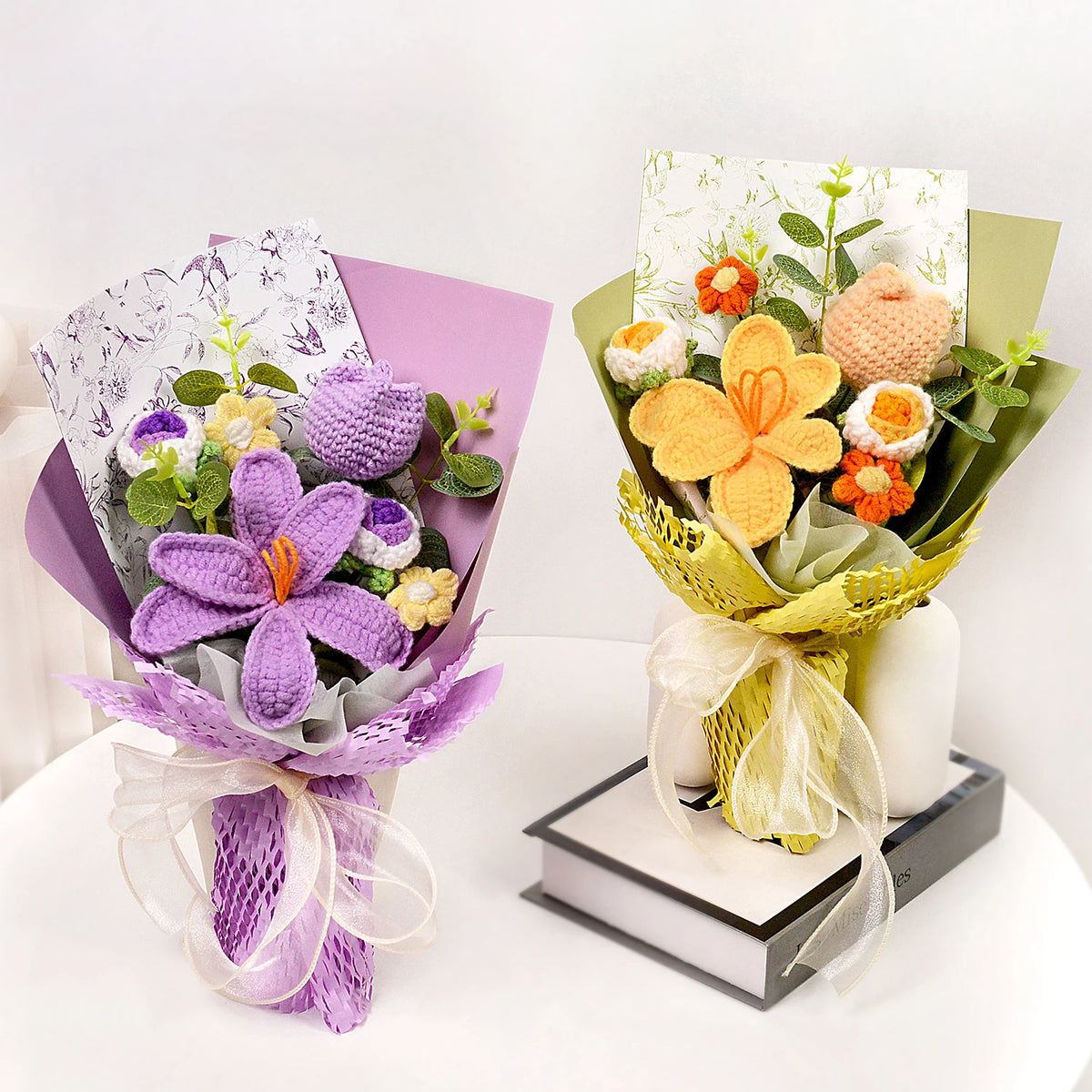 A handmade crochet tulip bouquet wrapped in purple paper and presented with a candle.