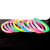 A collection of colorful silicone bracelets featuring a Jesus heart design arranged in a row.