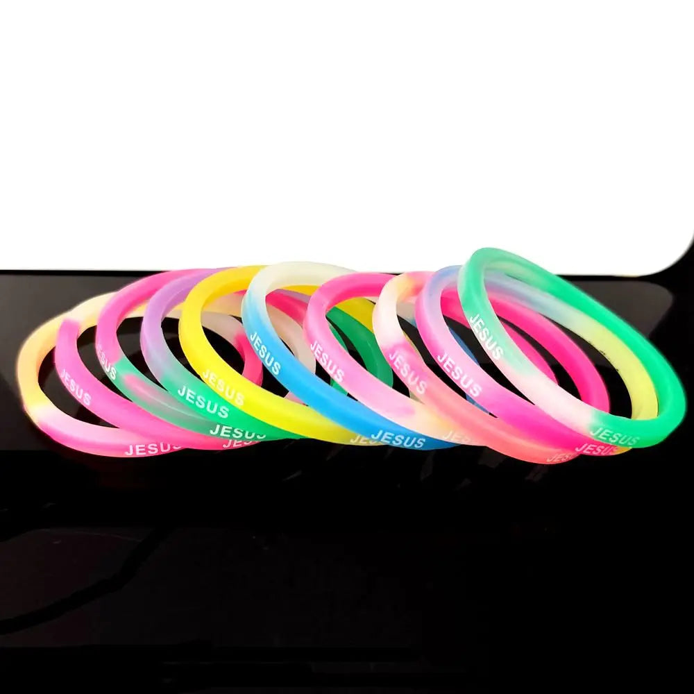 A collection of colorful silicone bracelets featuring a Jesus heart design arranged in a row.