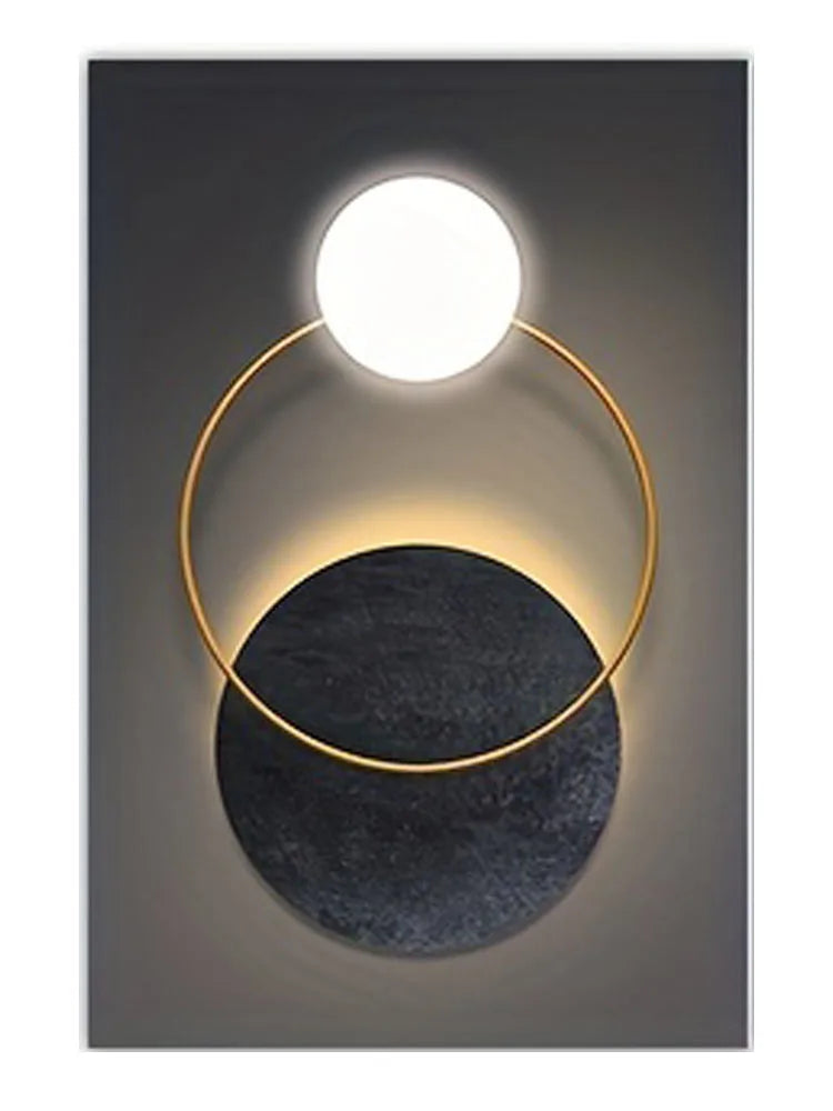 Modern geometric canvas wall art featuring a gold ring light illuminating a round white bulb above a dark circular base.