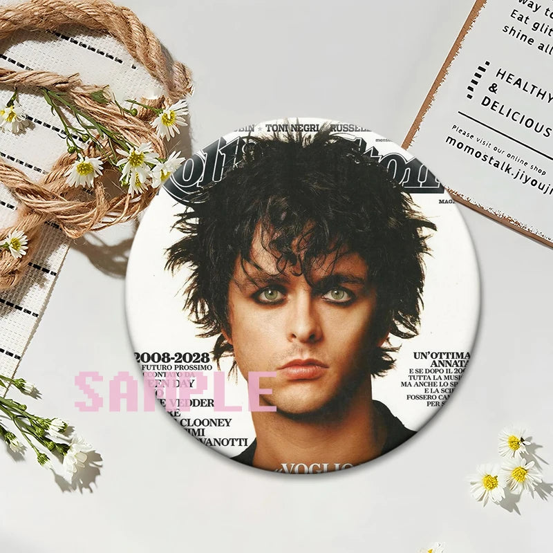 A button pin featuring a portrait of a male musician with dark, curly hair and intense eyes.