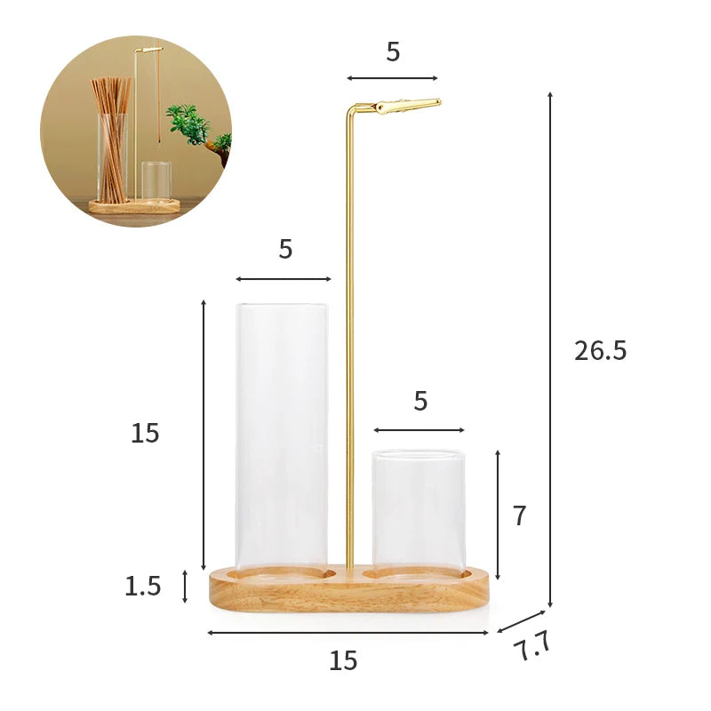A tall, gold-colored glass incense holder with a removable ash catcher and wooden base.