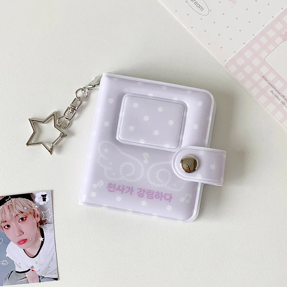 A white mini snap button photo album with a clear window and a silver chain attached, featuring Korean text.