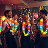 Group of people celebrating with glow-in-the-dark LED Hawaiian lei necklaces at an event