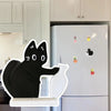 Black acrylic cat whiskers decor attached to a refrigerator
