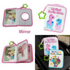 A pink cloth baby photo album with a mirror and a colorful illustration of a dinosaur.
