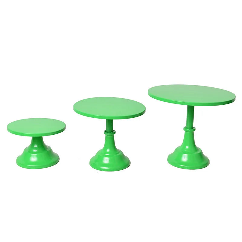 A set of three bright green metal cake stands for dessert display or afternoon tea.