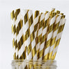 A bundle of paper drinking straws featuring gold and white striped patterns.