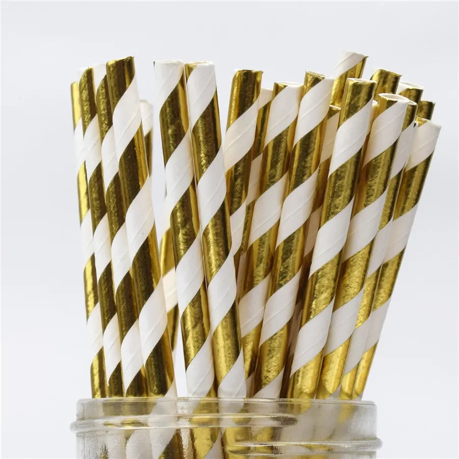 A bundle of paper drinking straws featuring gold and white striped patterns.