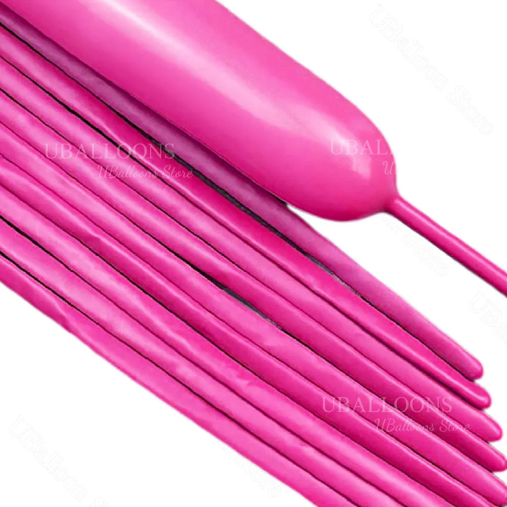 A close-up of pink magic twisting balloons with long necks and tubes.