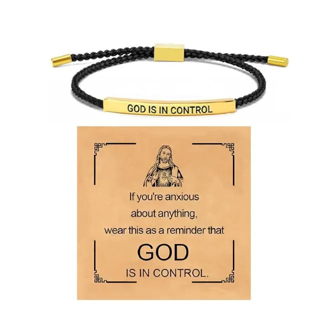 A gold-toned stainless steel bracelet with the inscription God Is in Control and a card featuring the same message.