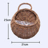 A round woven wicker wall hanging basket with a handle and a clear plastic insert.