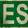 Vintage metal street sign with the text ARIES AVE on a dark green background.