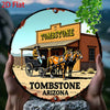 A vintage western tombstone sign featuring a wooden building and a horse, set against a scenic landscape.