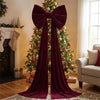 A deep red velvet Christmas tree bow with long streamers decorated a festive holiday display.