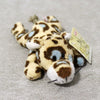 A cute plush tiger toy with brown and white stripes is shown against a gray background.