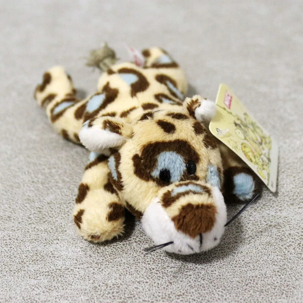 A cute plush tiger toy with brown and white stripes is shown against a gray background.