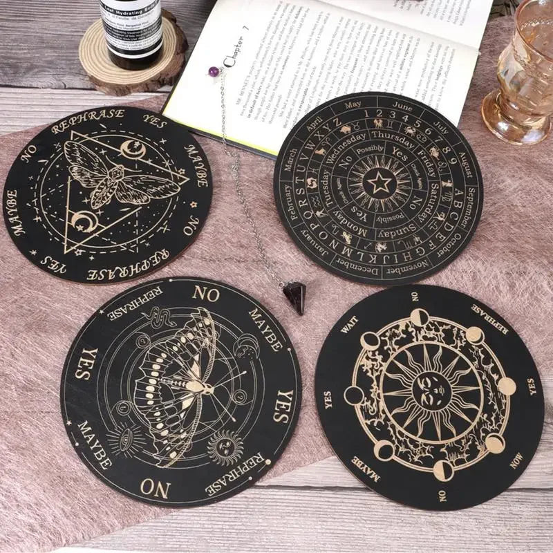 A collection of tarot-style divination cards, including a star wheel and a moon wheel, laid on a wooden surface.