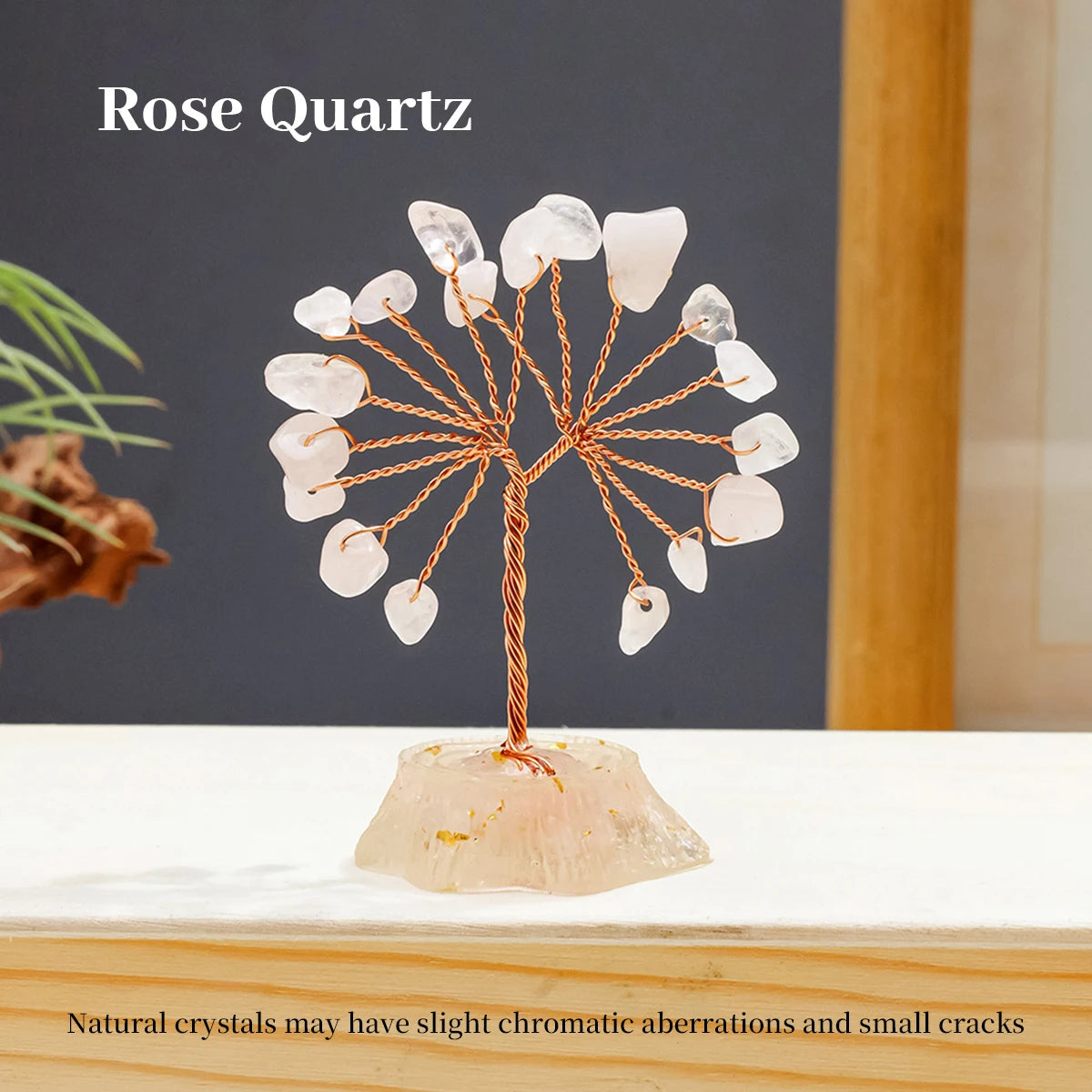 A Rose Quartz crystal tree featuring natural pink and white quartz stones branching out from a base.
