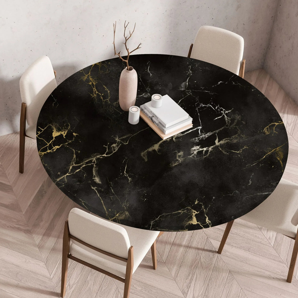 A round black marble print tablecloth is set on a wooden table with white chairs.