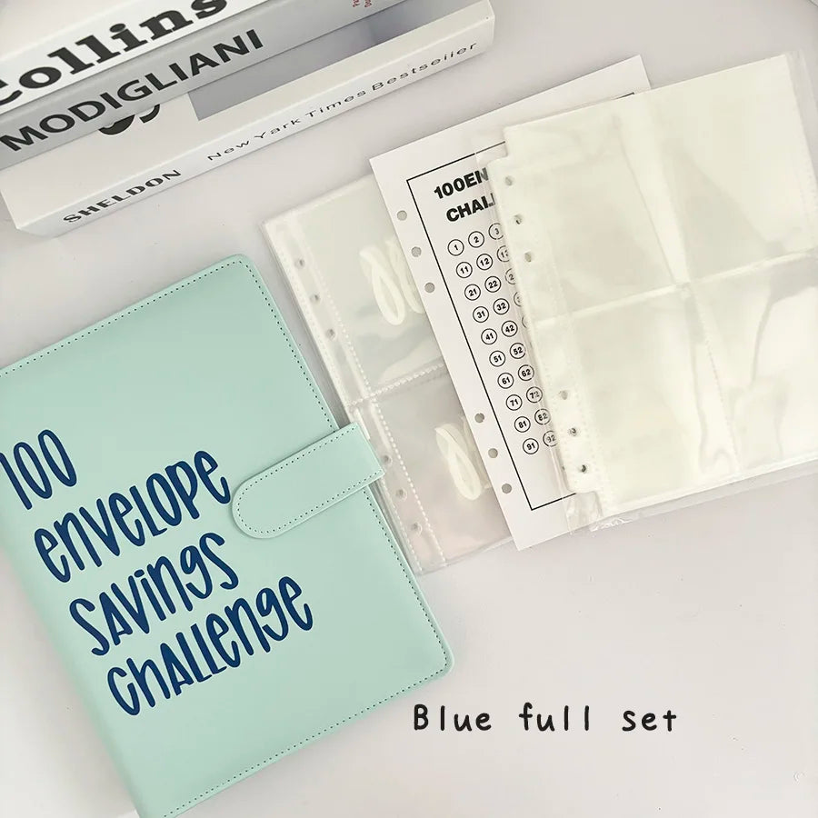 A blue A5 binder for a 100 envelope savings challenge with numbered clear pockets and a protective cover
