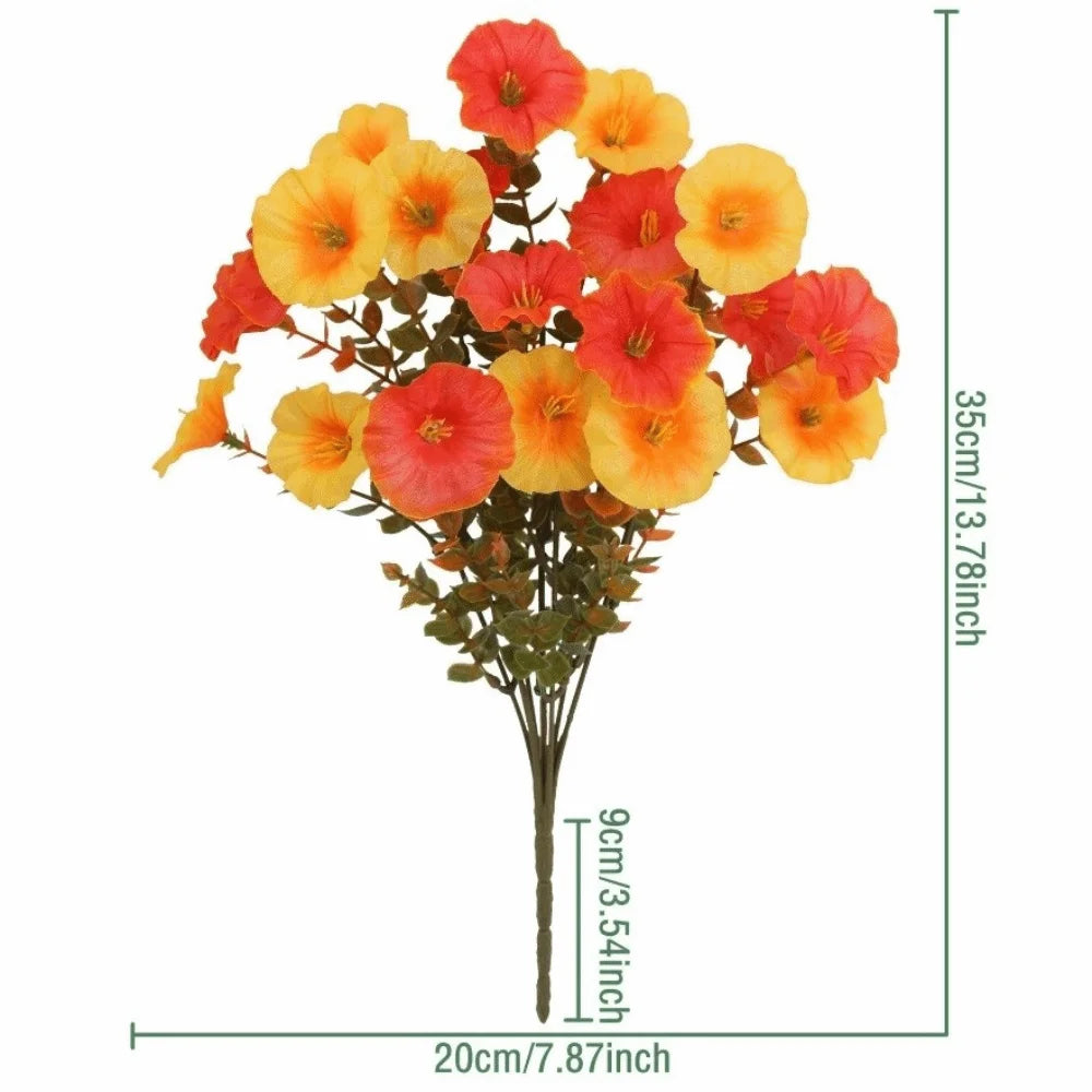 A bouquet of artificial pansy flowers in shades of orange and red with green eucalyptus stems.