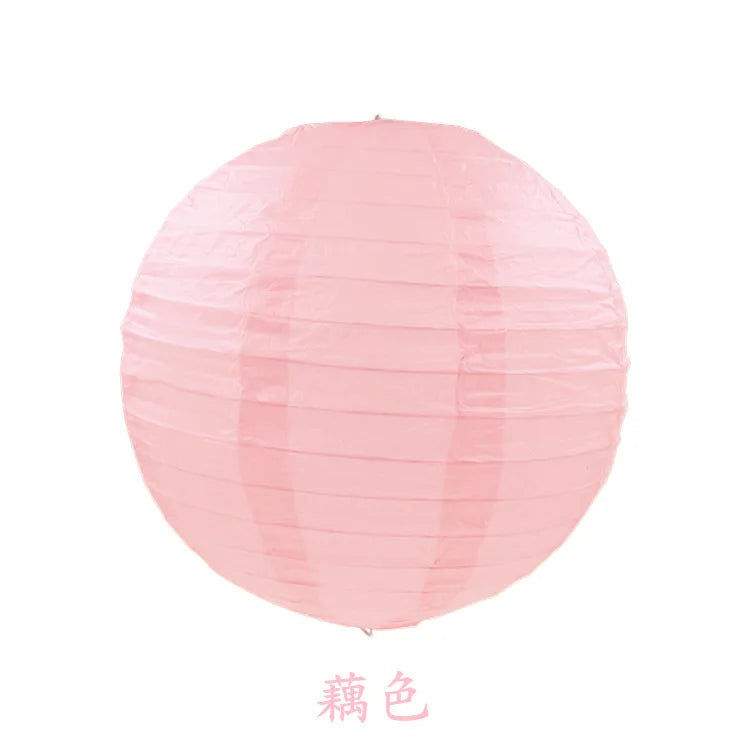 A round pink paper lantern used for parties and weddings.