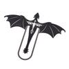 A black metal bookmark shaped like a four-winged dragon.