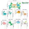 A set of nine dinosaur-themed party items including a banner, balloons, and disposable tableware for a birthday celebration.