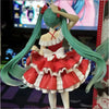 A 20cm PVC collectible figurine of Hatsune Miku in a red and white dress with long green hair.