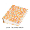 A 6 inch 100 photos album with an orange floral pattern cover and white pages.