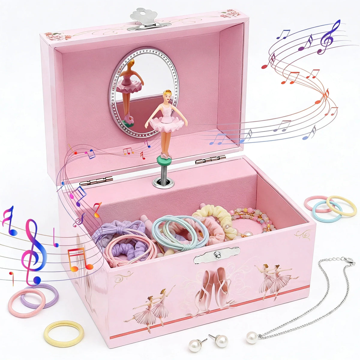 Pink wooden music box featuring a ballet dancer figurine and various jewelry items like rings and necklaces.