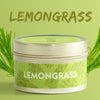 A jar of Lemongrass natural soy wax travel candle with green label and lemongrass stalks.