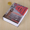 A book titled Underground London featuring a red double-decker bus and a tower, placed on a wooden surface.