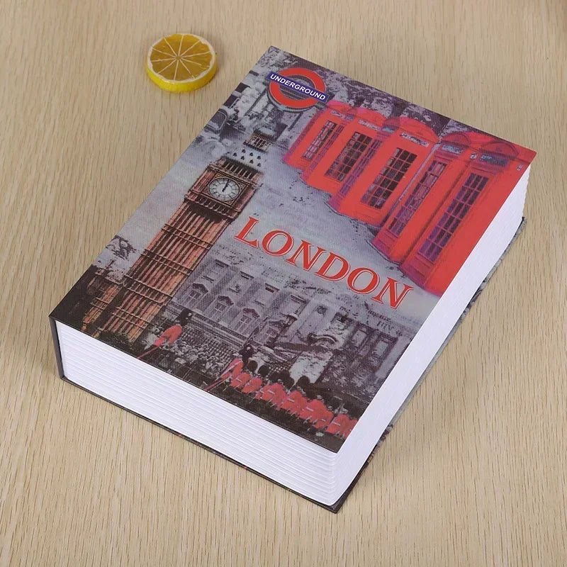 A book titled Underground London featuring a red double-decker bus and a tower, placed on a wooden surface.