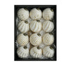 A set of twelve white and gold retro shatterproof Christmas tree ball ornaments displayed in a black box.