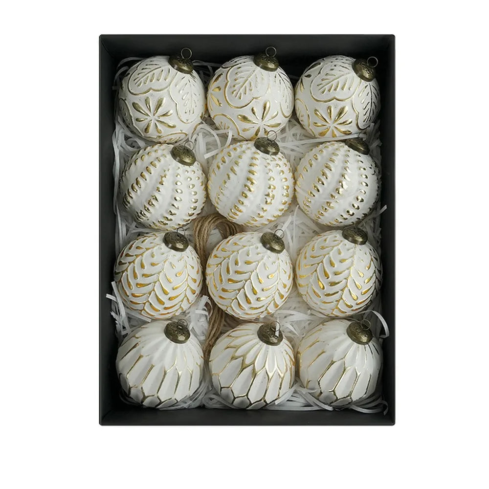 A set of twelve white and gold retro shatterproof Christmas tree ball ornaments displayed in a black box.