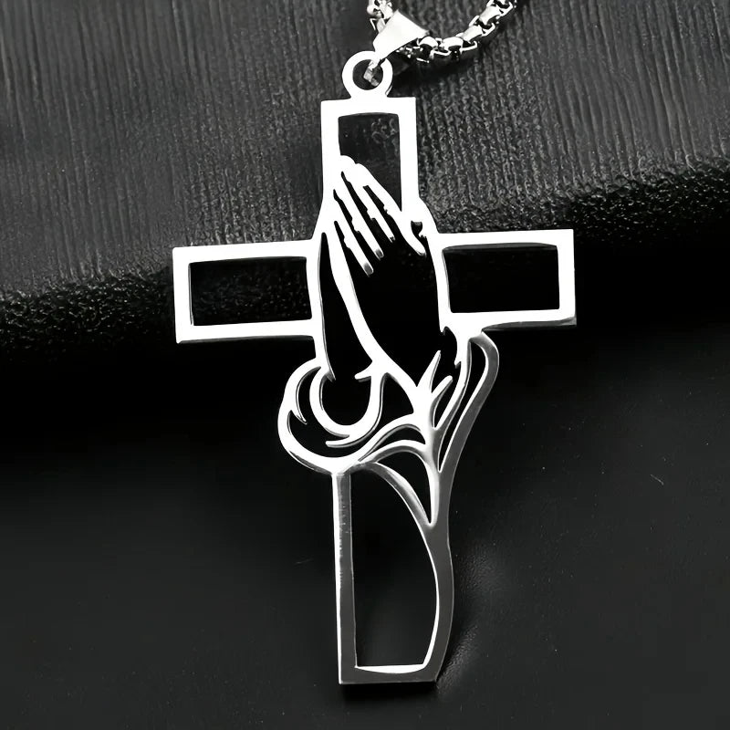 Silver pendant featuring a cross with praying hands design.