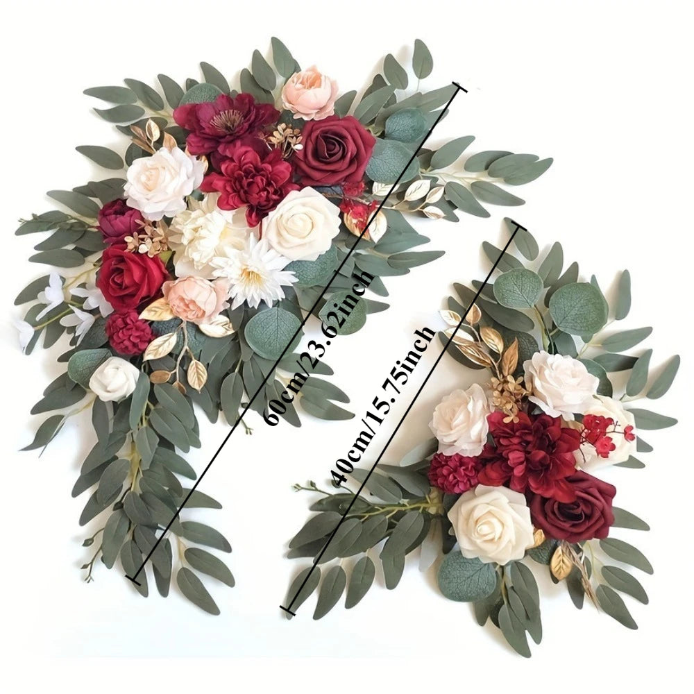 A floral kit featuring deep red and blush roses mixed with white flowers and dusty green eucalyptus leaves.