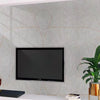 A flat-screen television mounted on a gray marble-patterned wall above a white cabinet.