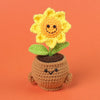 Handmade crochet sunflower desk companion with a smiling face growing out of a pot
