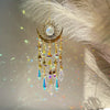 A hanging gold star moon wind chime decoration with dangling crystal beads and gold accents.