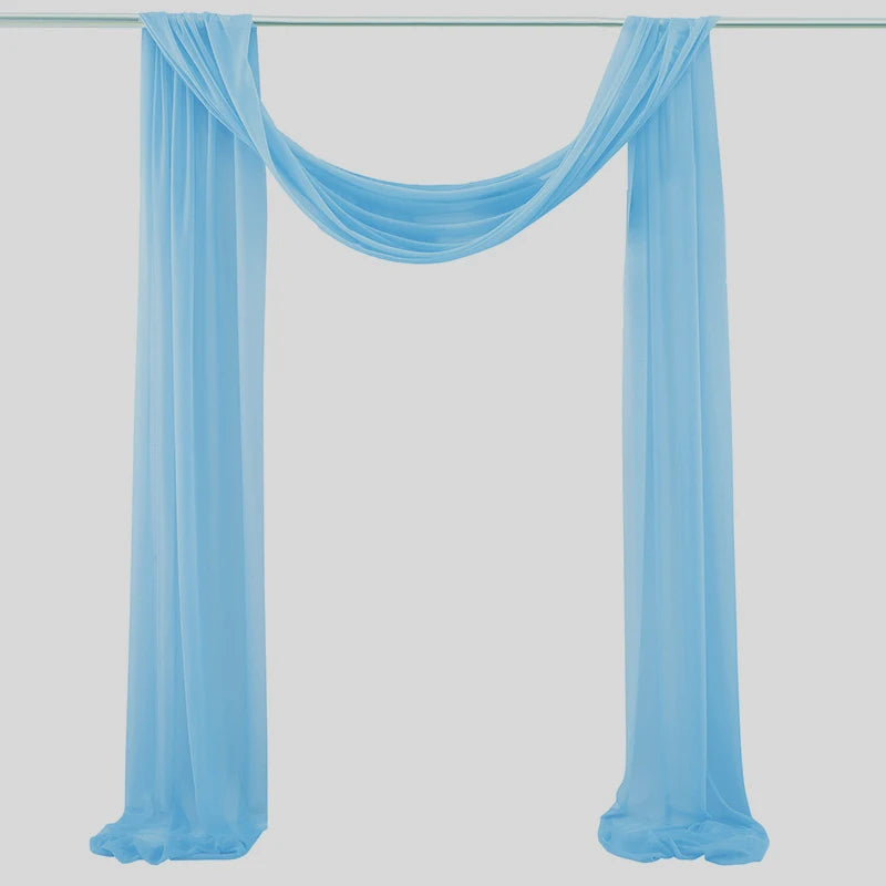 Light blue chiffon fabric panels draped as a wedding arch backdrop