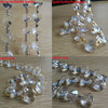 A collection of silver and gold butterfly buttons, rings, and glass bead strands for home decor.